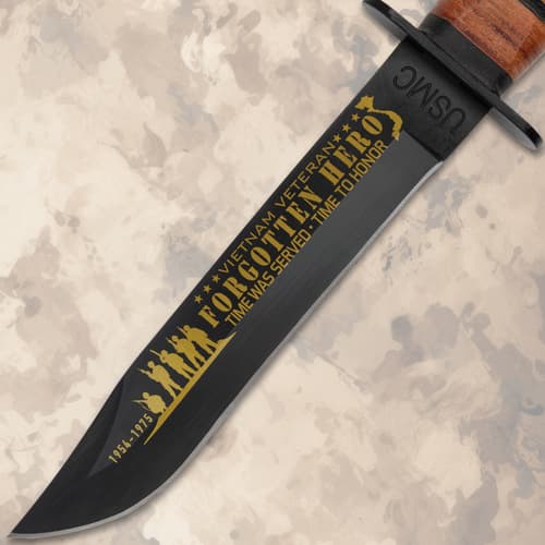 Close-up of knife blade with 'Forgotten Hero' inscription
