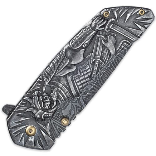 The knife’s handle has sculpted artwork of a Shogun warrior posed with a sword.