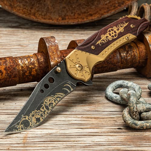 Steampunk knife on rustic wood and metal surface