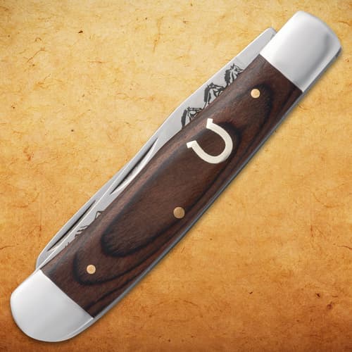 Closed pocket knife with wooden handle and horseshoe inlay