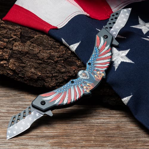 Patriotic knife with eagle design on wood and flag backdrop