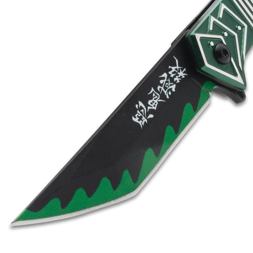 Close-up of knife blade with green wave pattern