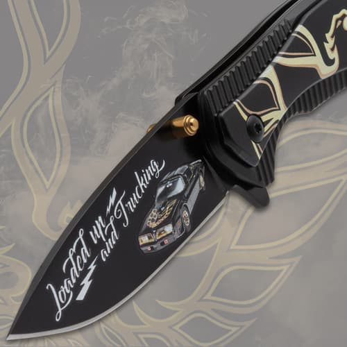 Close-up of knife blade with car design and decorative handle