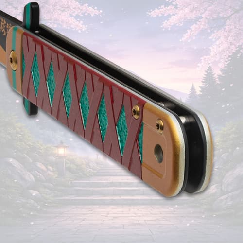 Close-up of folded knife handle with red and teal design