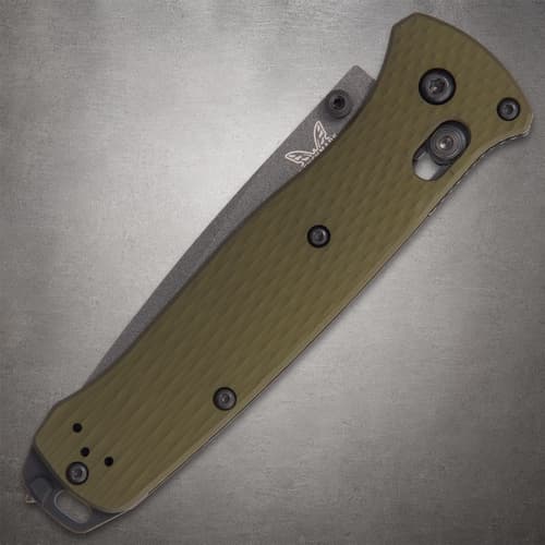 Closed Benchmade knife with green handle on gray surface