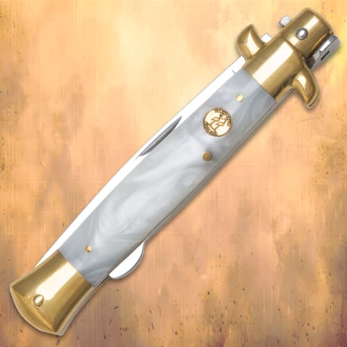 The knife’s mother of pearl handle is accented by brass-plated pins, bolsters, and shield.
