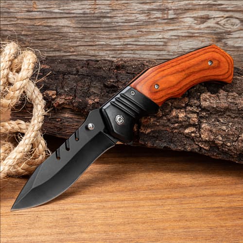 Knife with wooden handle on wood and rope background