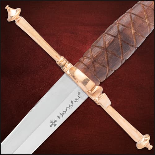 The Italian Dagger is shown secured in its brown leather sheath with gold-colored accents on the throat and tip.