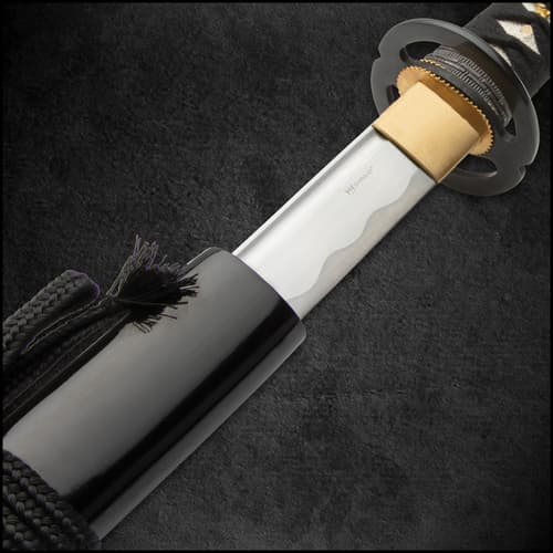 The 41 3/4” overall katana slides into its black, lacquered wooden scabbard, which has black cord-wrap accents