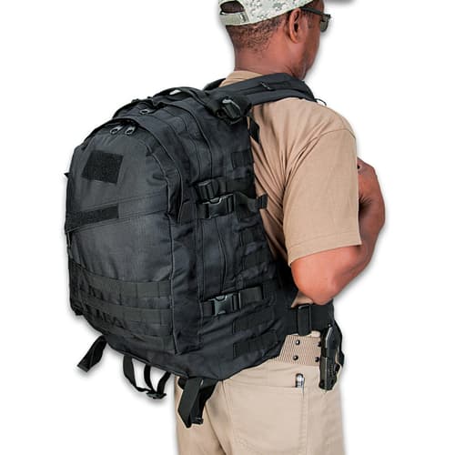 Person wearing a black tactical backpack