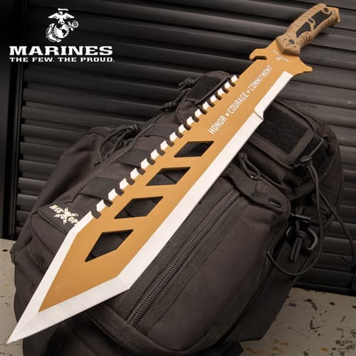 Tan machete with 'Honor, Courage, Commitment' on backpack