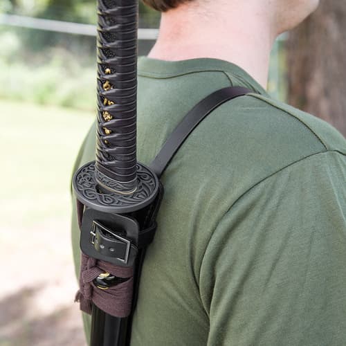 A zoomed view of one of the front straps of the shoulder harness holding the sword in place.