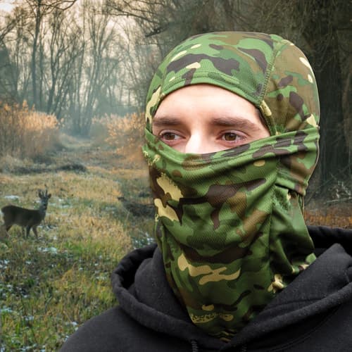 a person wearing the jungle camo mask