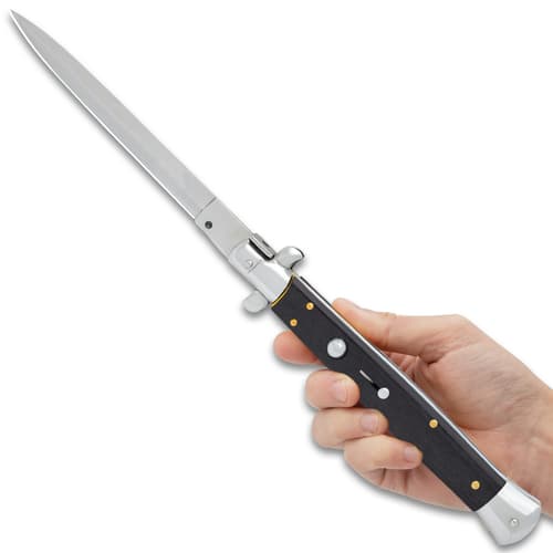 The 7 1/4” closed pocket knife has black acrylic handle scales, and the push button and slide lock are conveniently on top