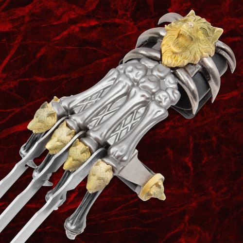 Close-up of claw weapon handle with wolf and lion designs