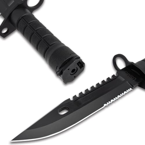 The knife has a 7” stainless steel blade with a sawback spine, extending from a muzzle-ring guard, and a laser-etched “USMC”