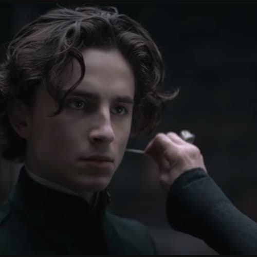 Dune film scene showing a young man with the Gom Jabbar needle held near his neck
