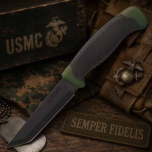 USMC tactical knife on a wooden surface with military gear