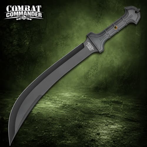 Black tactical knife with a long curved blade and textured handle on a green background
