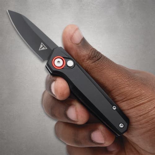 Hand holding a black folding knife