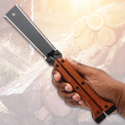 Hand holding a folding saw with wooden handle
