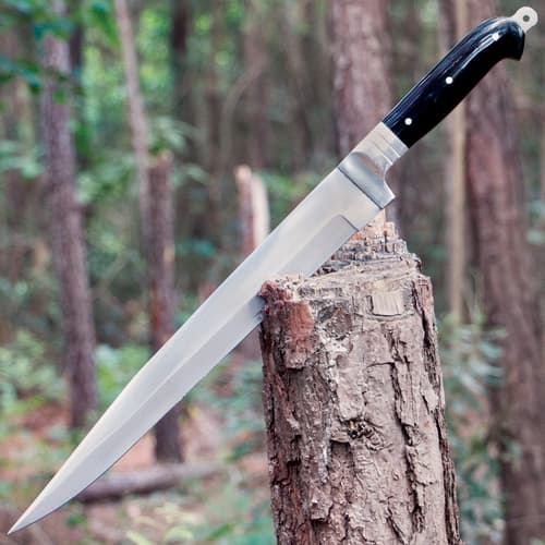 Arabian Khyber Bowie Knife in outdoor setting, wedged into a tree stump