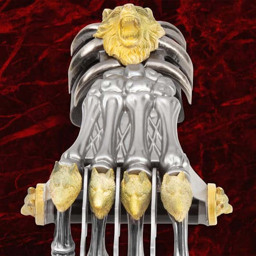 Front view of claw weapon with detailed wolf and lion motifs