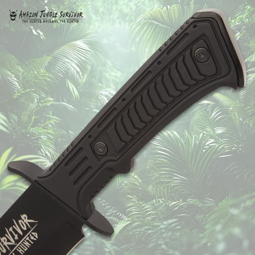 Close-up of black knife handle with jungle background