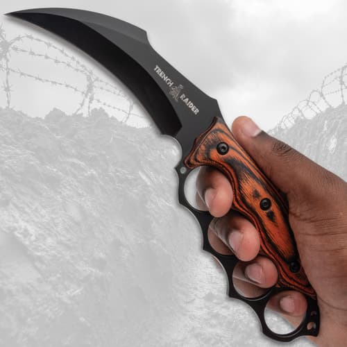 Hand holding a knife with a curved blade and wooden handle