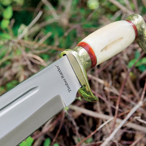 Close-up of knife handle and blade in outdoor setting