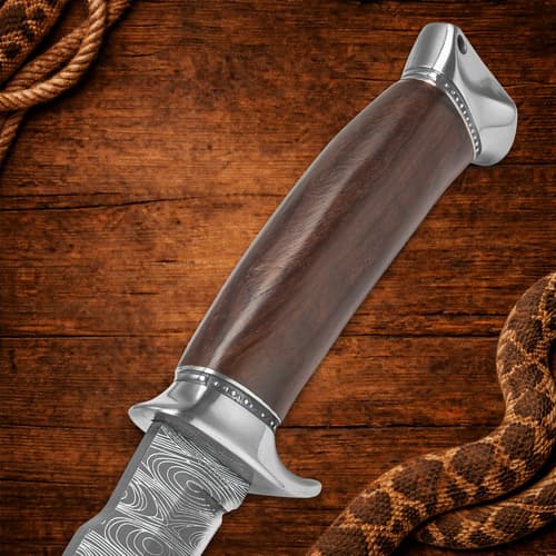 Close-up of knife handle with wooden texture on wood background