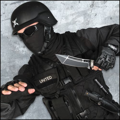 The knife’s black oxide coated blade has a modified tanto point and custom nylon belt sheath.