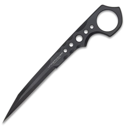 "Undercover" stinger knife being held in front of a black knife sheath attached to a military-style boot.