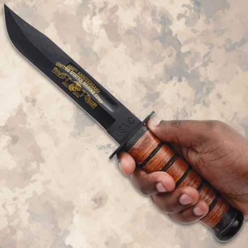 Hand holding USMC 250th anniversary combat knife