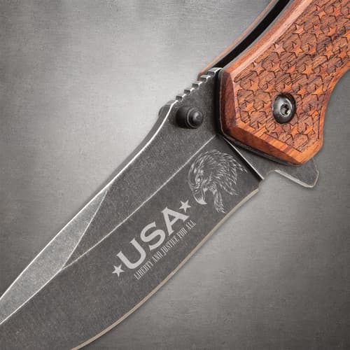 Close-up of the pocket knife's stonewashed blade with USA and eagle design