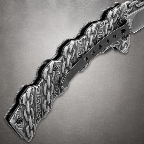 Close-up of knife handle with chain design