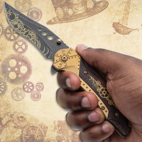 Hand holding a steampunk knife with gear design