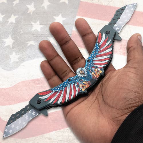 Hand holding eagle-themed knife with American flag background