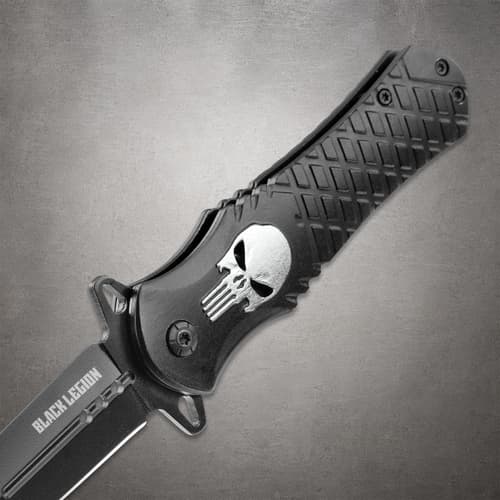 Detailed view of the Black Legion pocket knife handle, showcasing the textured aluminum design and silver skull emblem