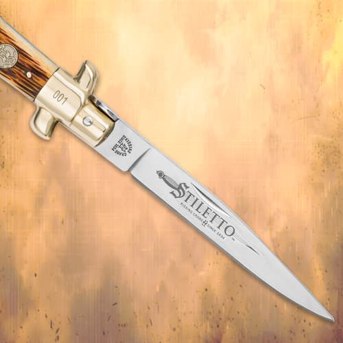 Close-up of the Kissing Crane Stiletto Knife blade with etchings