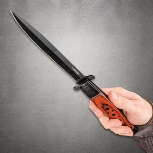 Ridge Runner Speed Demon knife with black blade and wooden handle held in hand