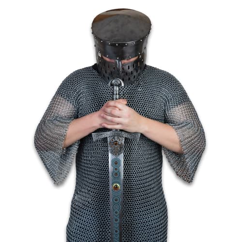 Person in chainmail holding a decorative sword