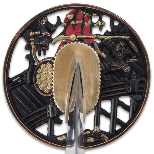 The hardwood handle is traditionally wrapped in faux rayskin and red cord and has an intricately detailed metal tsuba