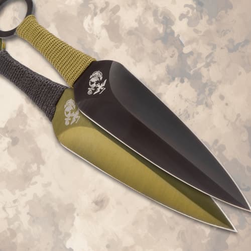 Close-up of two USMC throwing knives with cord grips