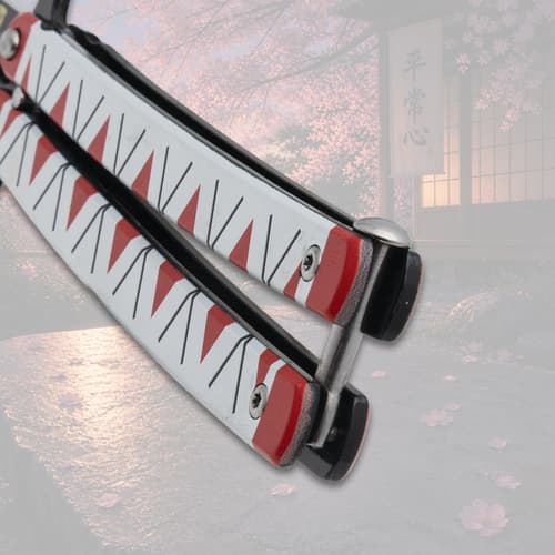 Close-up of butterfly knife handle with red and white pattern
