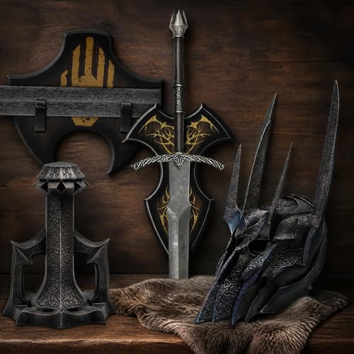 Medieval sword, shield, and helmet with intricate designs on a wooden chest