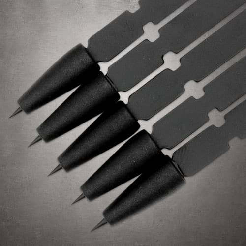 Close-up of five black On Target darts arranged diagonally, showing pointed tips, tapered heads and notched flat shafts