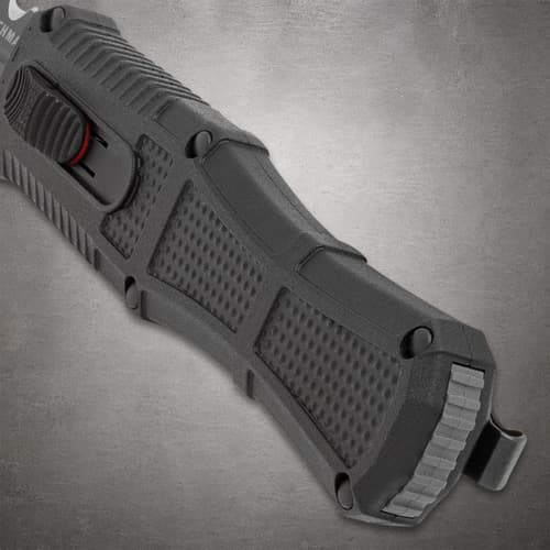 Close-up of black knife handle showing textured grip and button