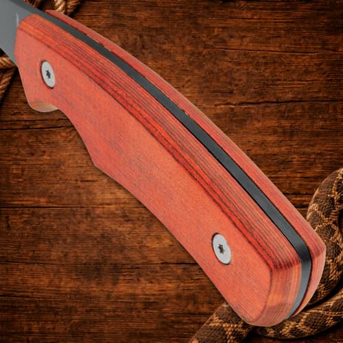 Close-up of wooden handle with screws on wood