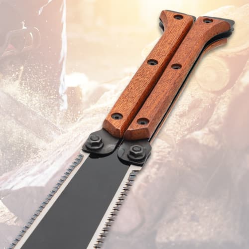 Folding saw with wooden handle on wood background